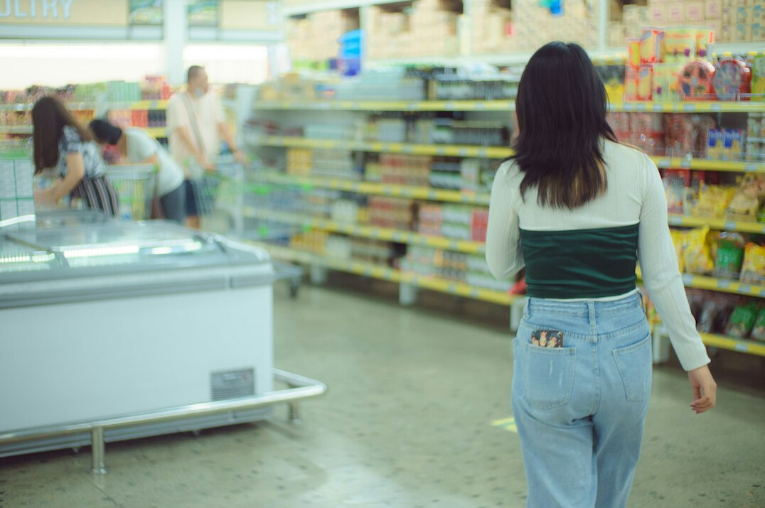 store detective watching shoppers