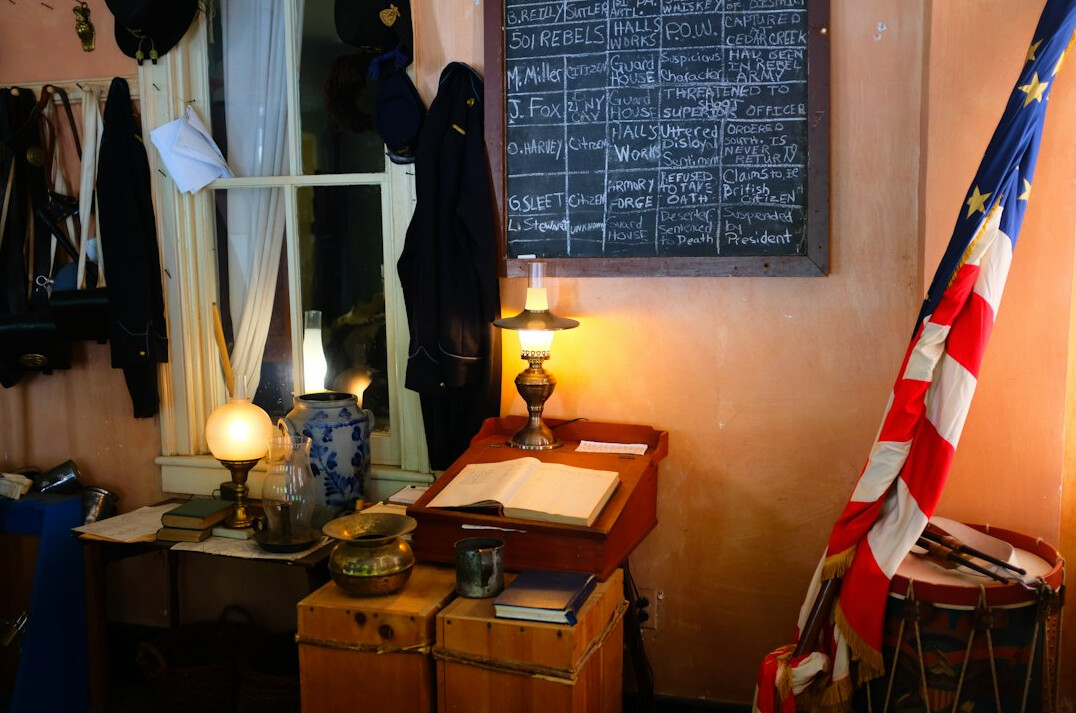 Vintage writing desk with a typewriter, books and a small Uruguayan flag